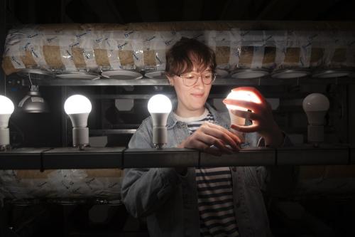 Student working with light bulb.